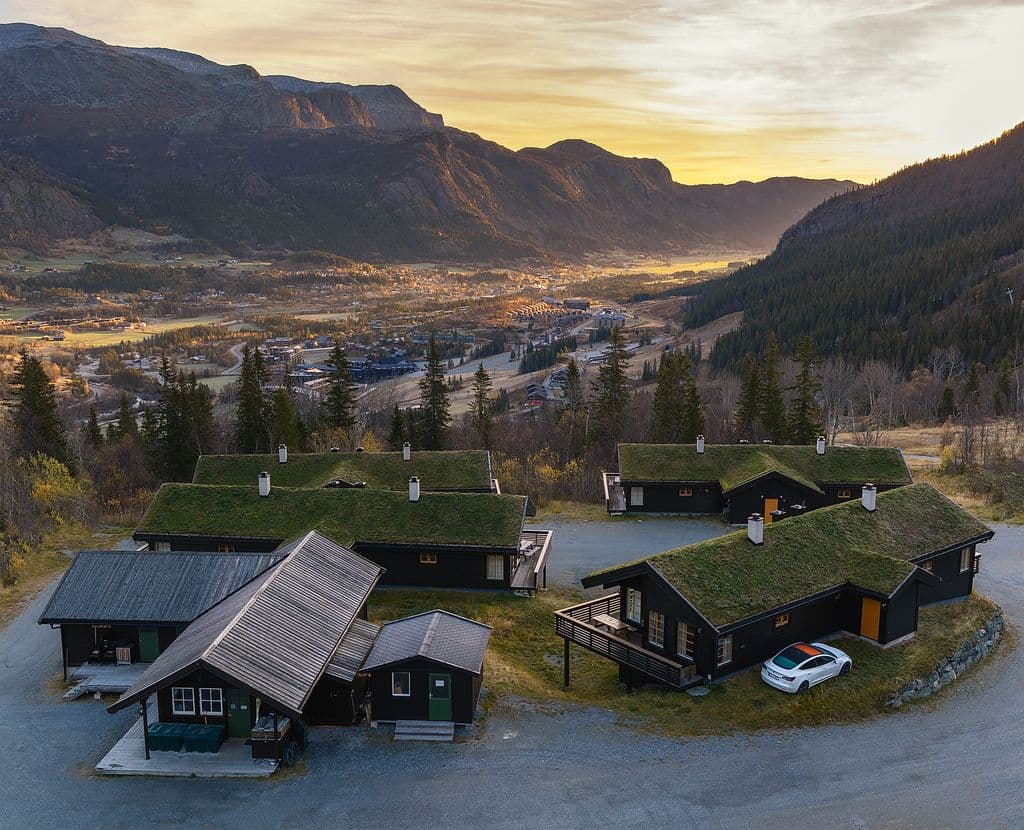 Traditional turf-roof cabins above Hemsedal valley at sunset, late autumn, Hallingdal Norway